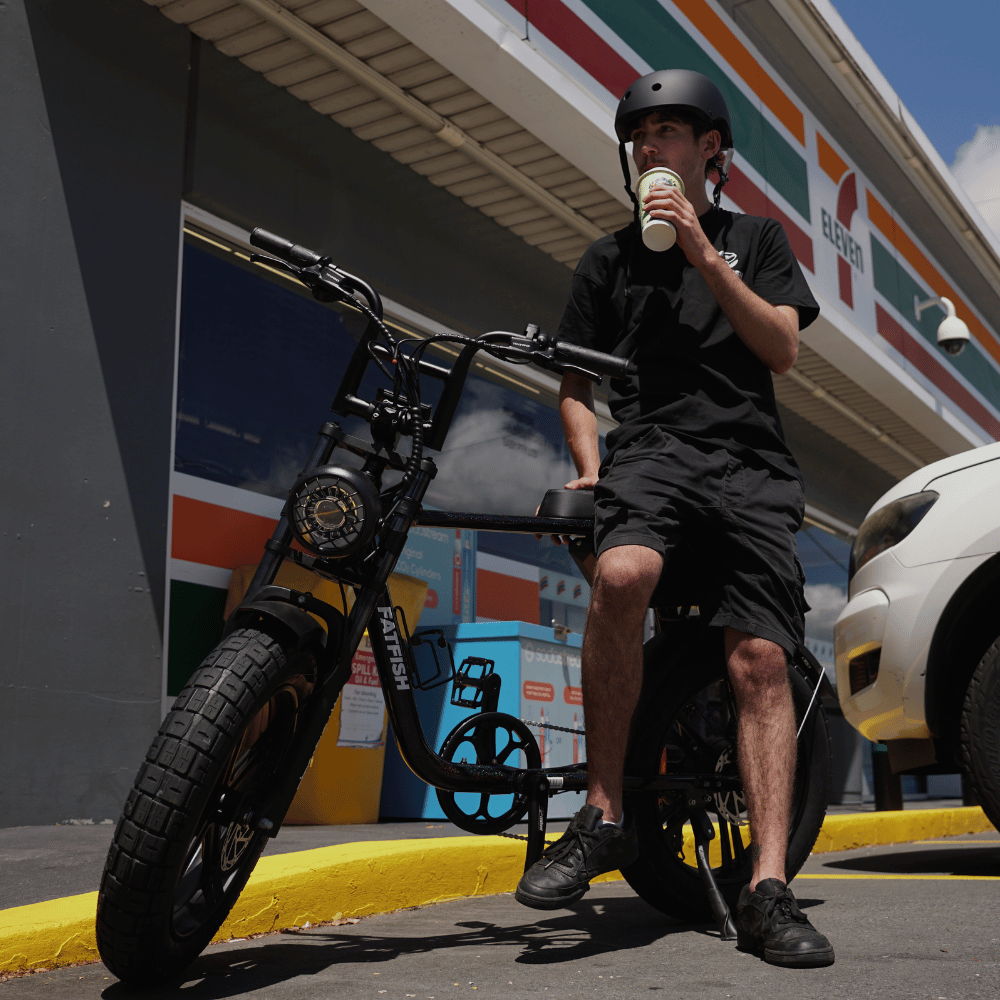 Helmeted rider with a black Fatfish OG 2.0 outside a convenience store