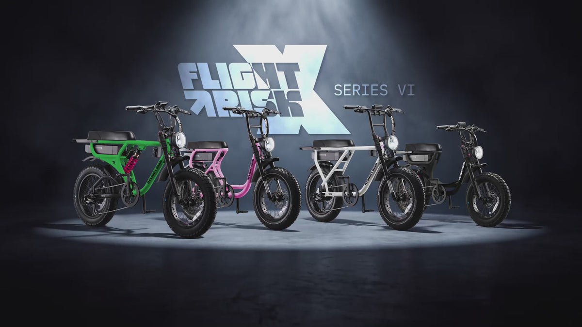 Four Flight Risk Series VI electric bikes in a dramatically lit studio